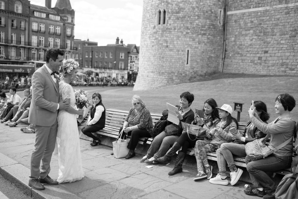 Couple having their picture taken by visitors outside Windsor Castle